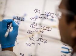 Scientist drawing up a molecular structure.